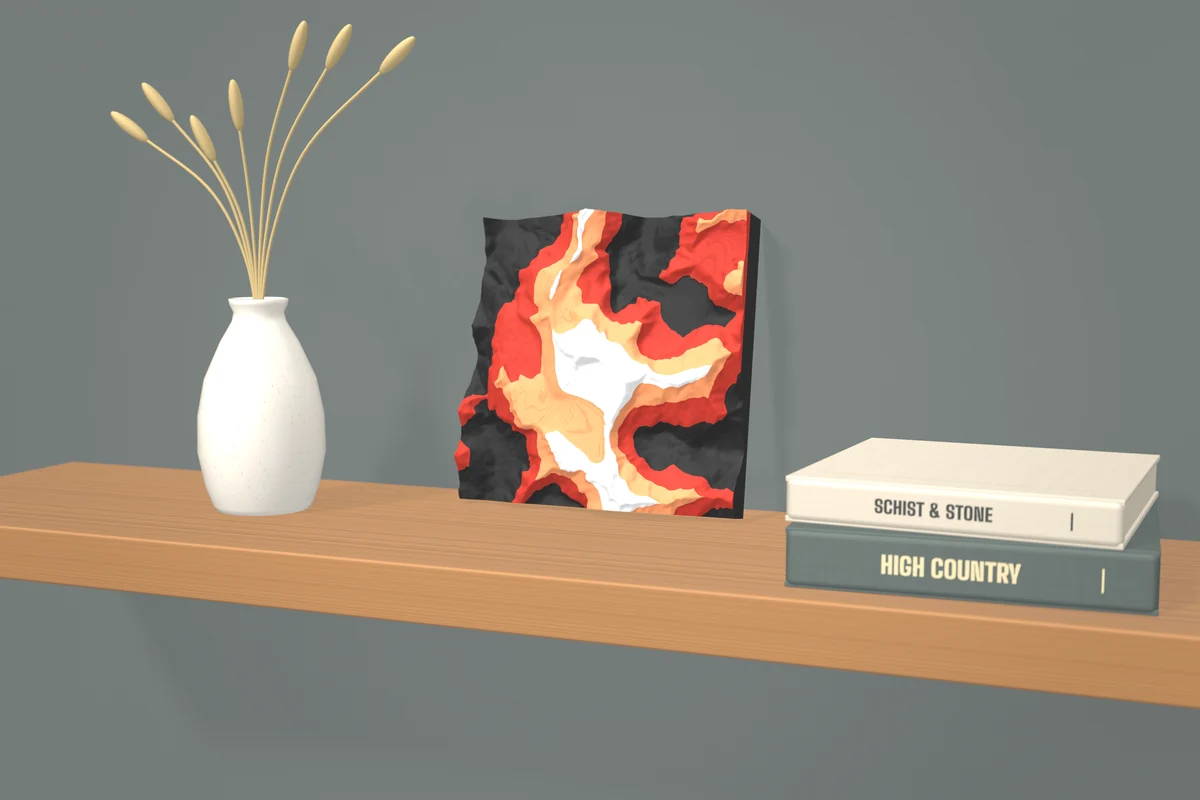 Render: the Tititea / Mt Aspiring tile in Ember colours standing on an oak shelf, leaning on the wall, between a speckled vase of dried grass and two cloth-bound books.